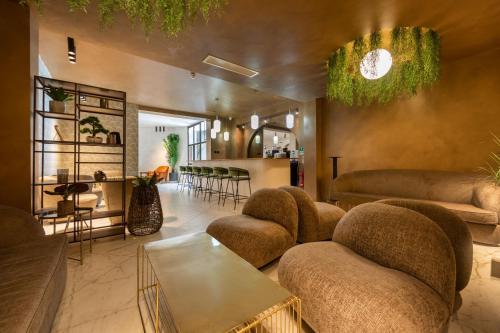 a living room with couches and chairs and a table at King Solomon Hotel- Golders Green in London