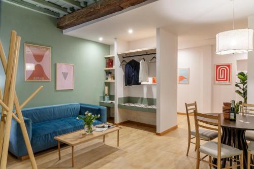 a living room with a blue couch and a table at Salotto Monti in Rome