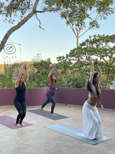 a group of women doing yoga on mats at Pousada Maya in Alto Paraíso de Goiás