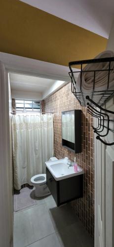 a bathroom with a sink and a toilet at vacation home in Roseau
