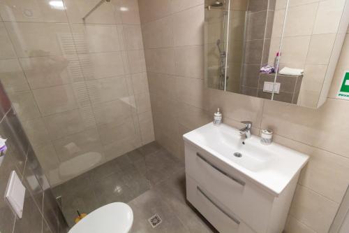 a bathroom with a toilet and a sink and a shower at Gajeva Rooms - Stockholm apartment SELF CHECK-IN in Virovitica