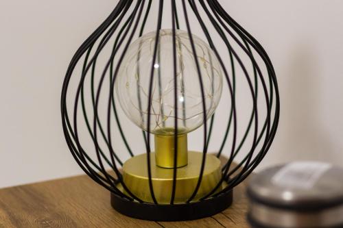 a black glass lamp sitting on top of a table at Gajeva Rooms - Stockholm apartment SELF CHECK-IN in Virovitica