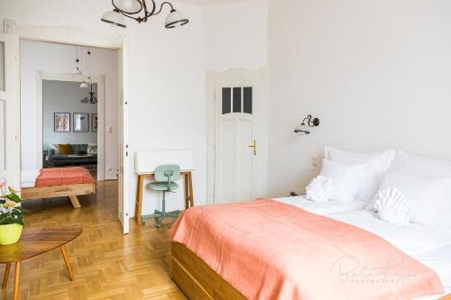 a bedroom with a large bed and a desk at Captain Buda Apartment in Budapest