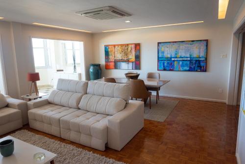 a living room with a couch and a table at Bela Vista Copacabana in Rio de Janeiro