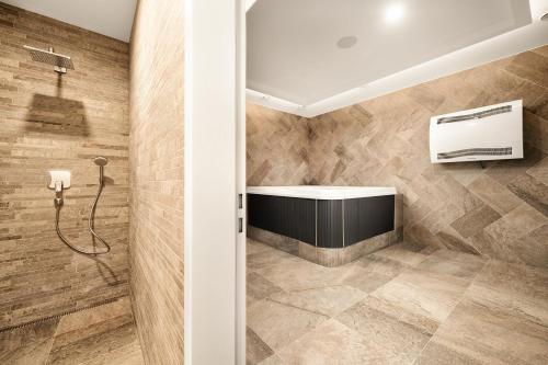 a bathroom with a tub and a shower stall at Apartmány Horská, Vrchlabí in Vrchlabí