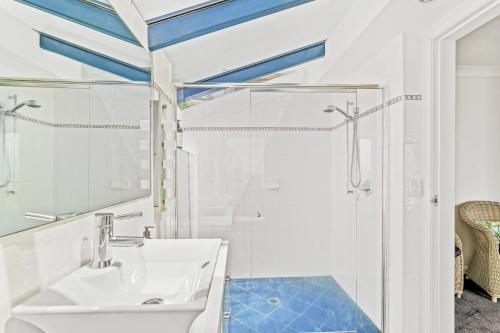 a bathroom with a sink and a shower at Spacious Home with Ocean Views, Close to Beach in Wamberal