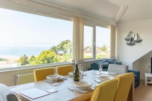 a dining room with a table and chairs and a large window at Higher Upover in Woolacombe