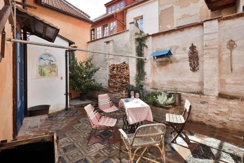 a patio with a table and chairs in a building at Apartmány Za branou in Kutná Hora