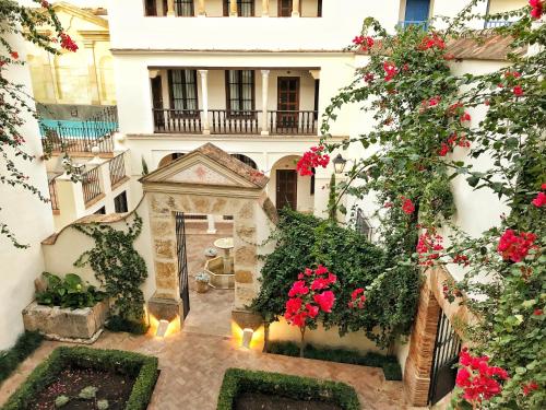 an external view of a building with flowers and plants at Las Casas de la Judería de Córdoba in Córdoba