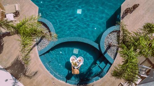 an overhead view of a swimming pool with a pool noodle in the water at Tzante Hotel Zakynthos, Adults Only in Laganas