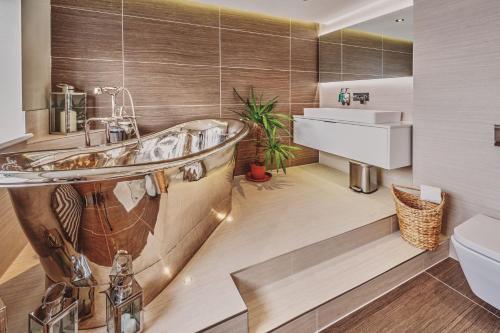 a bathroom with a tub and a sink at Loch Ness Mansion in Invermoriston