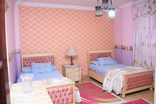 Postel nebo postele na pokoji v ubytování Kenzy guest house