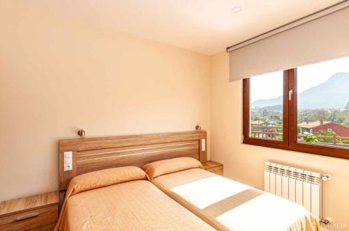 A bed or beds in a room at Apartamento 4 personas en la naturaleza Bisonte