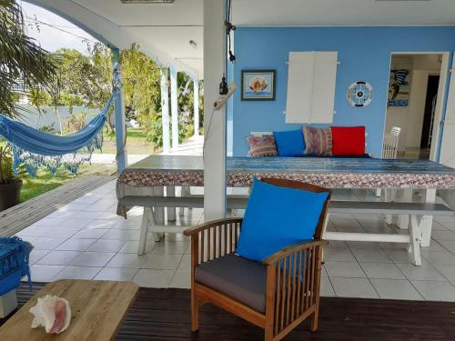 a room with a table and a chair and a bed at Villa ensoleillée avec piscine privée à Saint-François in Saint-François
