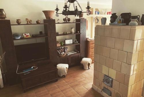 a living room with a tv and a tiled floor at Bella Garden in Balatonszárszó