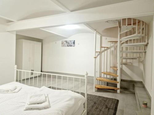 a bedroom with a white bed and a spiral staircase at Luxury 4-rooms apartment in Berlin Z in Berlin