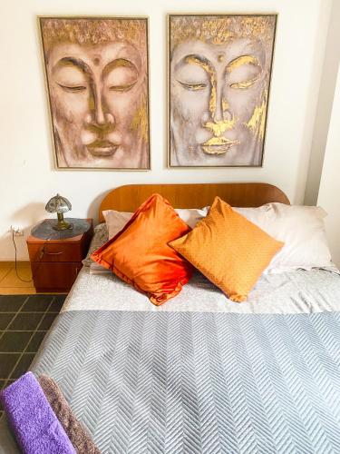 a bedroom with three pictures of faces on the wall at Pokoje Gościnne Emilio in Kudowa-Zdrój