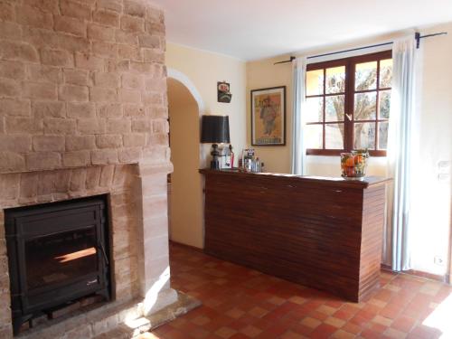 a living room with a brick fireplace and a window at maison florentine in La Gaude
