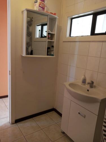 a bathroom with a sink and a mirror at HOWENH in Porvenir