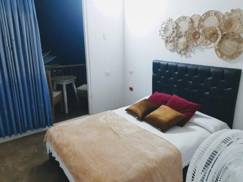 una camera con un letto con due cuscini sopra di Deep Forest Posadas Ecoturisticas a El Zaino