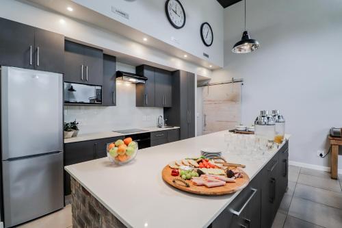 a kitchen with a counter with a pizza on it at The Greens Guest House in Knysna