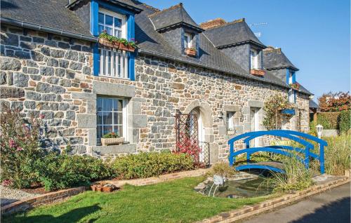 a blue bench in front of a stone house at 4 Bedroom Lovely Home In Langueux in Langueux