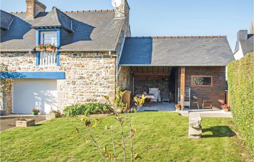 a brick house with a garage and a yard at 4 Bedroom Lovely Home In Langueux in Langueux