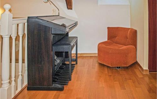 a living room with a desk and a chair at 4 Bedroom Lovely Home In Langueux in Langueux
