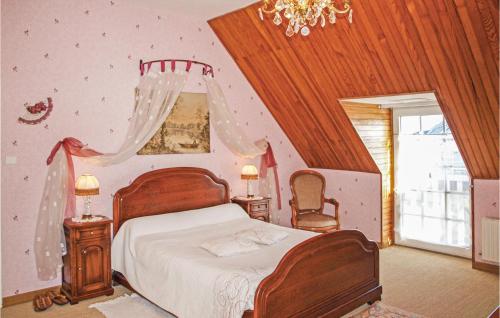 a bedroom with a bed and a chandelier at 4 Bedroom Lovely Home In Langueux in Langueux