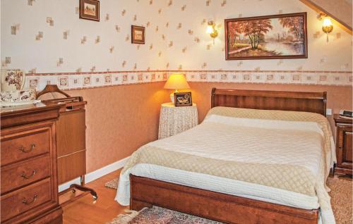 a bedroom with a bed and a dresser at 4 Bedroom Lovely Home In Langueux in Langueux
