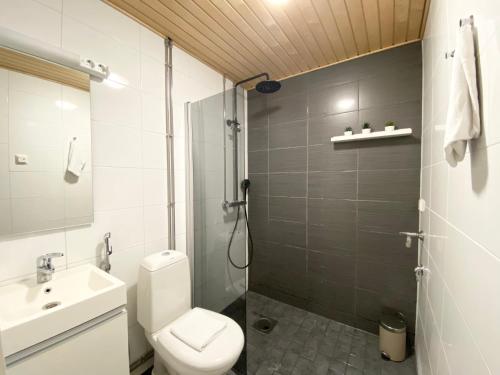 a bathroom with a toilet and a sink and a shower at Tammer Huoneistot - City Suite 2 - City View & Perfect location in Tampere