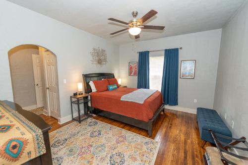 a bedroom with a bed and a ceiling fan at The Cozy, Fiber Internet, Roku TVs, Washer & Dryer, Near DT Chickasha & Leg Lamp! in Chickasha