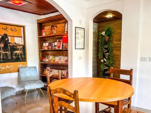 a dining room with a wooden table and chairs at Hotel & Pousada Sonho Meu in Florianópolis