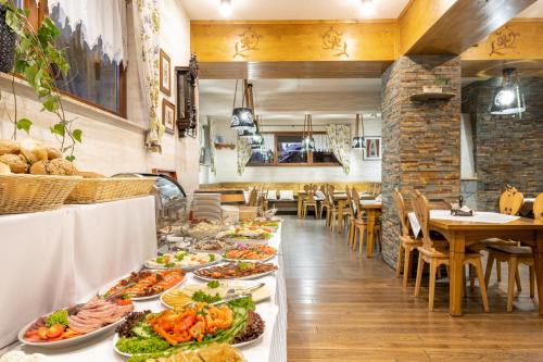 a buffet line with plates of food in a restaurant at Hotel Willa Pod Skocznią in Zakopane