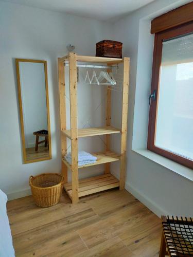 a room with a wooden shelf and a mirror at CASA SIETE LAGOS in Sinlabajos