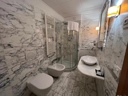 a bathroom with a toilet and a sink and a shower at Domus Stella Maris - Casa per Ferie in Ancona