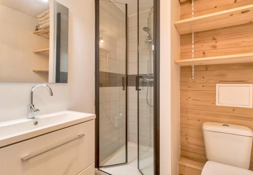 a bathroom with a shower and a toilet and a sink at Ambiance chalet pour 4 - 80m des pistes in Val Louron