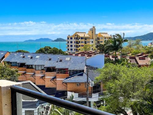 a view of a city with houses and the ocean at Hotel & Pousada Sonho Meu in Florianópolis
