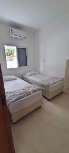 Postel nebo postele na pokoji v ubytování Pousada Village Maitinga