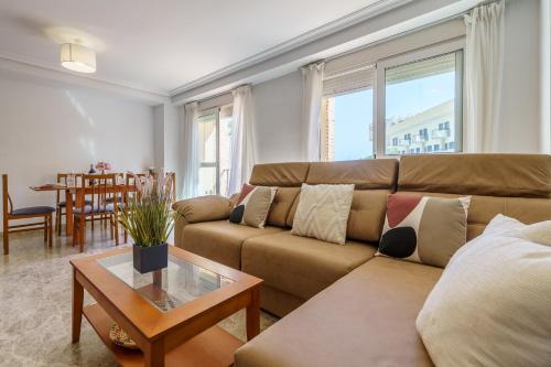 a living room with a couch and a table at MalagaSuite Torremolinos Lovely & Comfy in Torremolinos