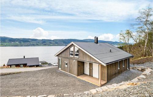 a small house on the side of a body of water at Stunning Home In Gjemnes With Wifi in Stokke
