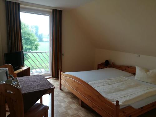 a bedroom with a bed and a large window at Gästehaus Grunewald Bed & Breakfast in Heiden