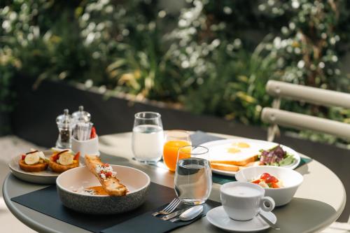 a table topped with plates of food and drinks at Neoma in Athens