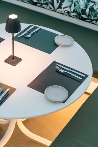 a white table with silverware on top of it at Neoma in Athens