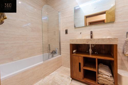 a bathroom with a sink and a shower at LUX VILLA with amazing BBQ, Pool Area & WIFI by 360 Estates in Is-Swieqi