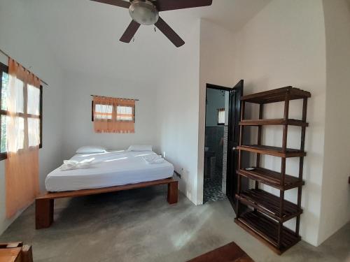 a bedroom with a bed and a ceiling fan at Hibiscus Garden in Santa Catalina
