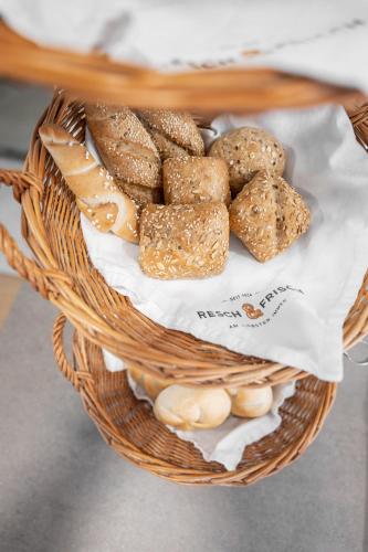 a basket filled with bread and cheese on a table at Landgasthof Allerberger in Wals