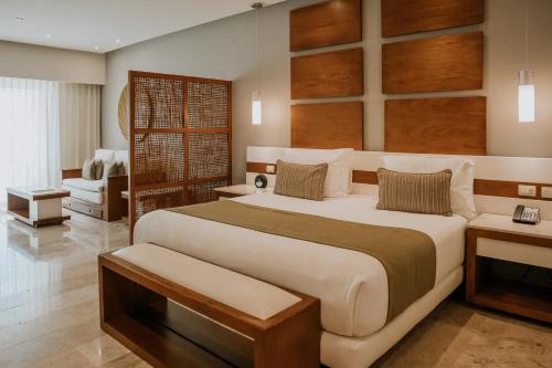 a bedroom with a large bed in a room at The Reef 28 Hotel & Spa - Luxury Adults Only - All Suites - With Optional All Inclusive in Playa del Carmen