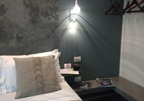 a bedroom with a bed with lights on the wall at Vittorio Veneto 25 in Modena
