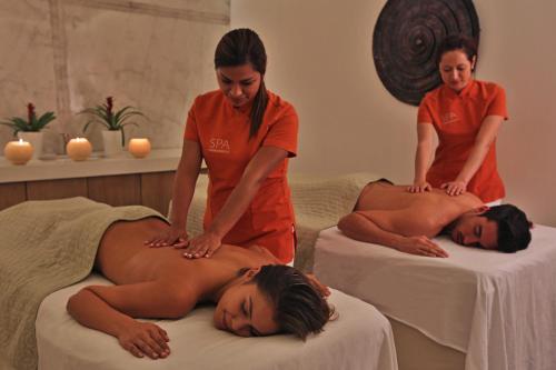 a womanolithing a woman laying on a bed at Intercontinental Real Guatemala by IHG in Guatemala